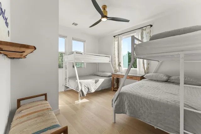 a bedroom with a bed and a large window