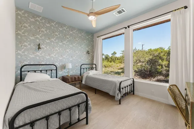 a bedroom with a bed and a large window