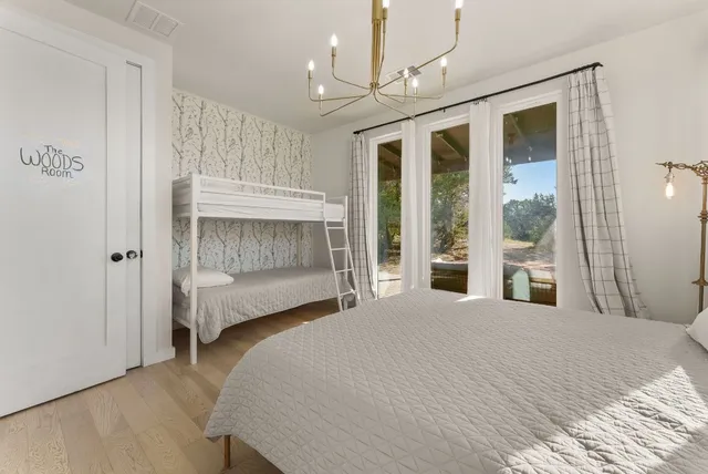 a bedroom with 2 bed and a window