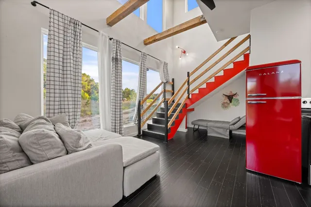 a view of a livingroom with furniture and hardwood floor