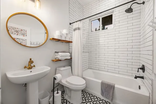 a bedroom with a large bed and a large window