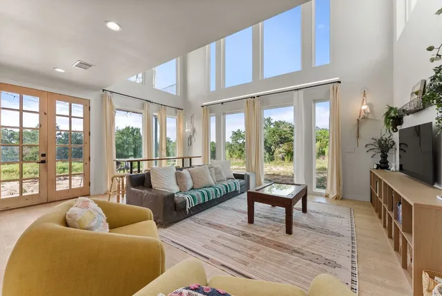 a living room with furniture tv and a table