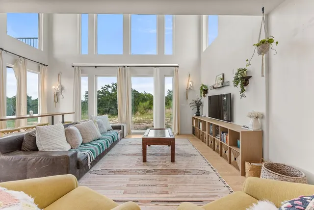 a living room with furniture and a large window