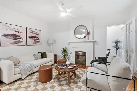a living room with furniture a fireplace and decor