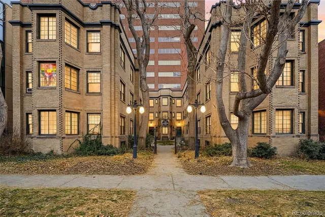 a view of a brick building next to a road