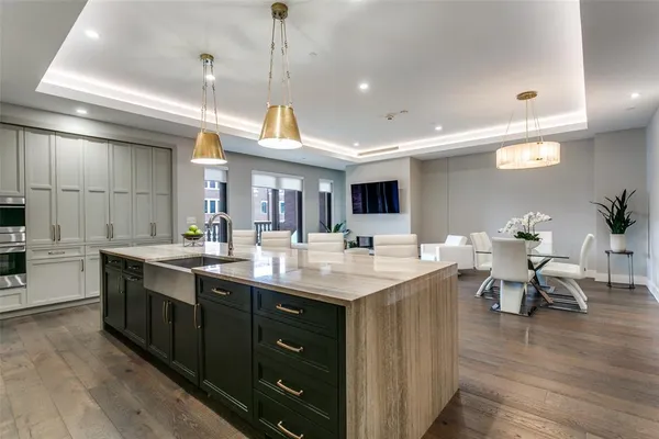 a kitchen with lots of counter space a sink and living room