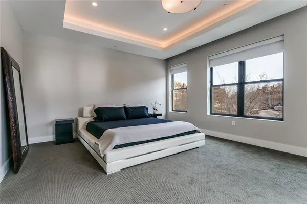 a spacious bedroom with a bed and a large window