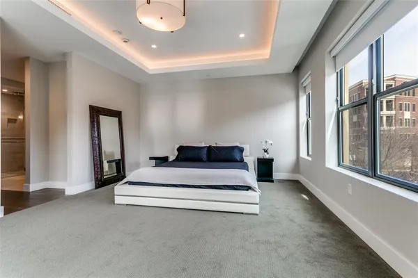 a spacious bedroom with a bed and window