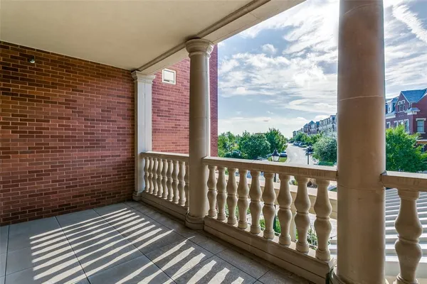 a view of a balcony with wooden floor