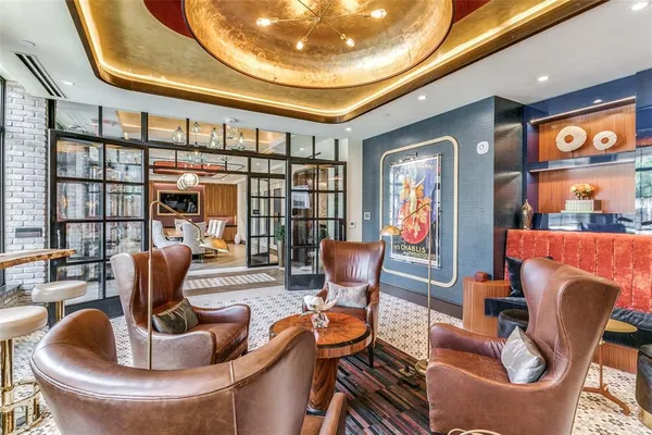 a living room with furniture and a floor to ceiling window