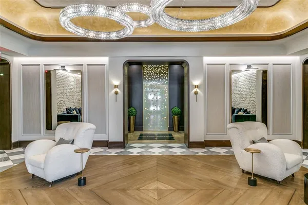 a living room with furniture and a large mirror