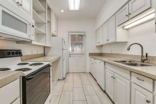 a kitchen with stainless steel appliances granite countertop a stove and a sink
