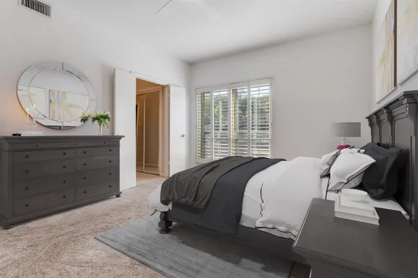 a bed room with a bed window and a mirror