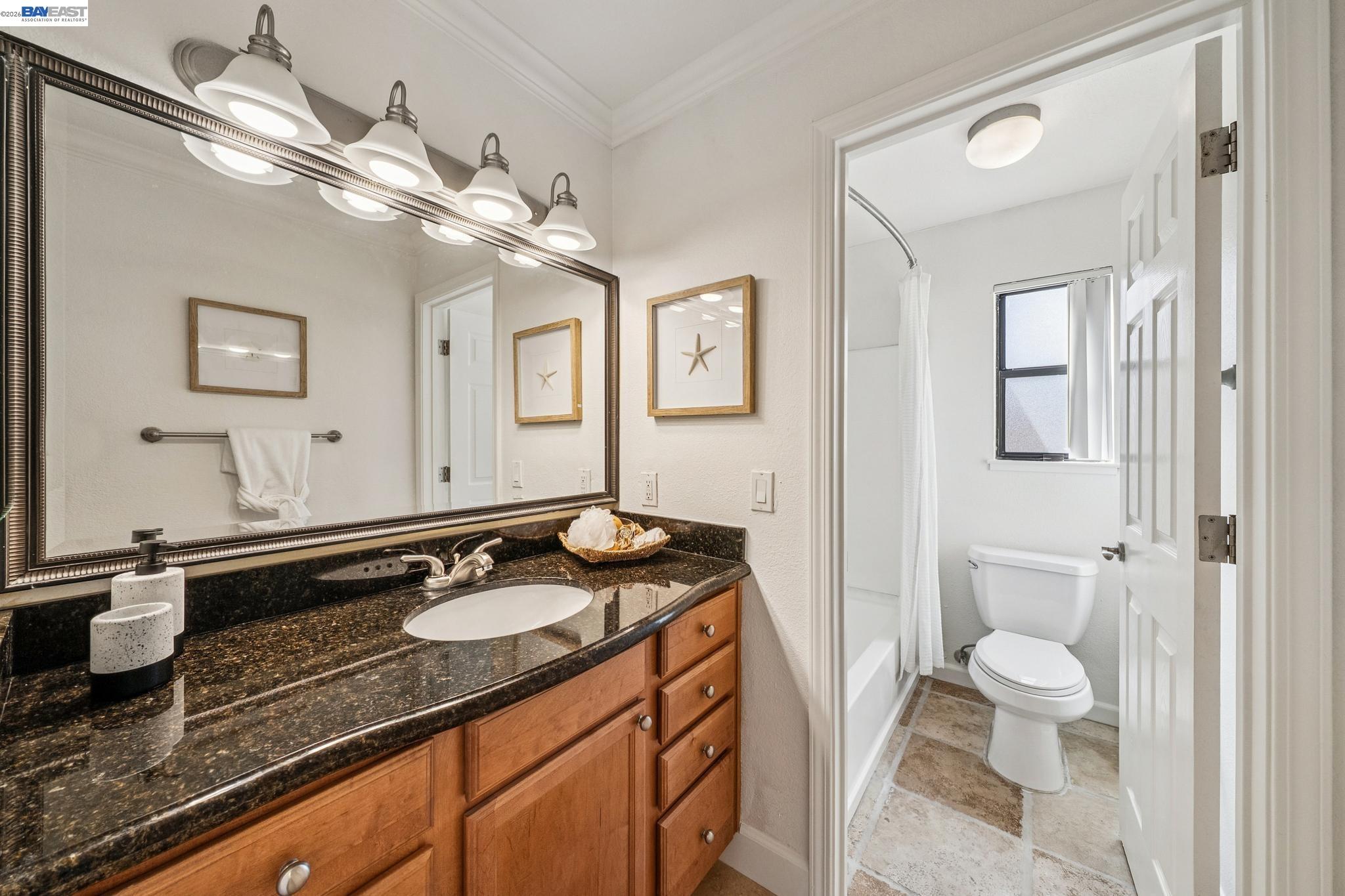 182 Eastridge Drive San Ramon, CA 94582 - Photo 22 of 54 a bathroom with a granite countertop sink a toilet a mirror and shower