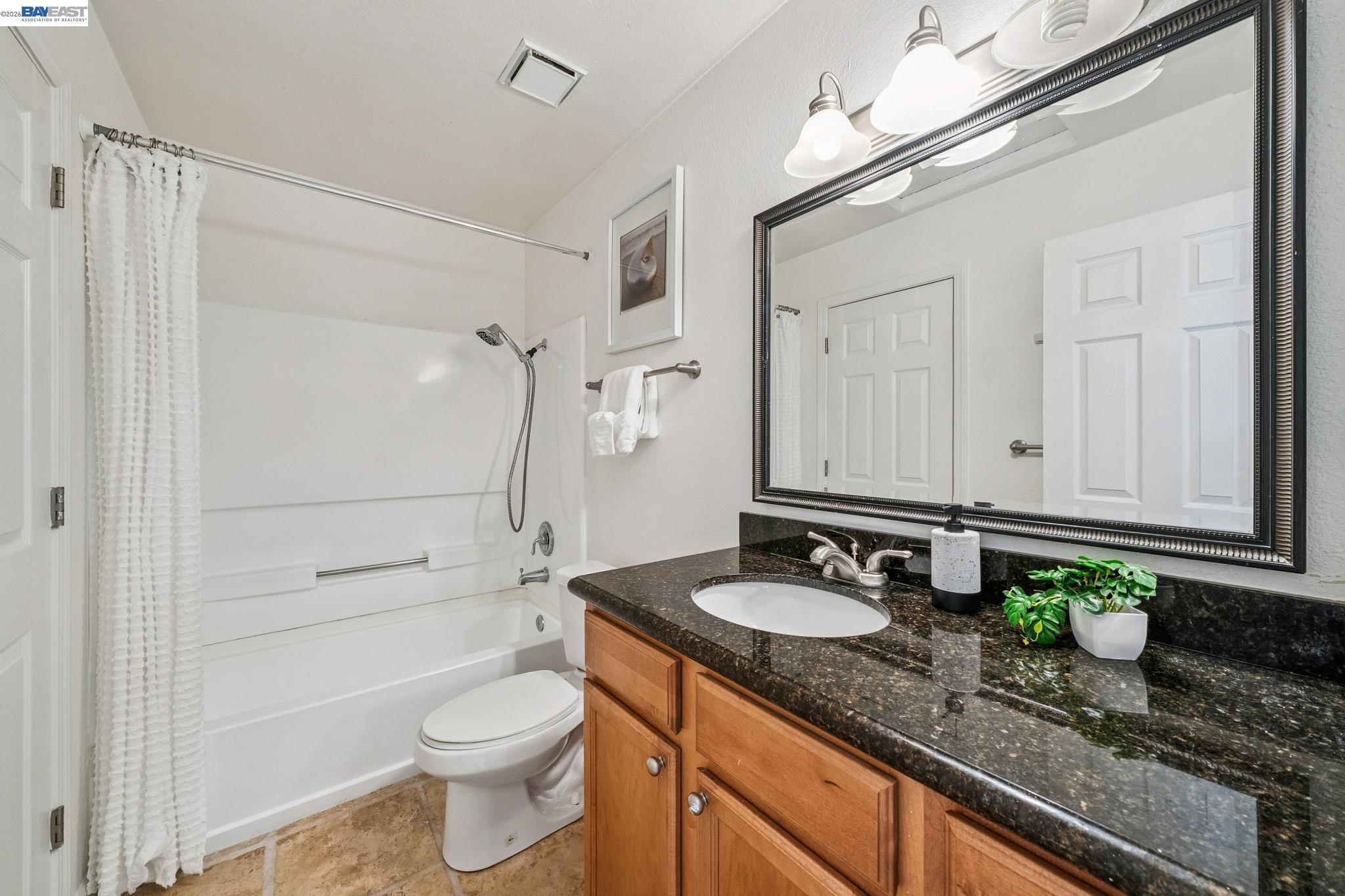182 Eastridge Drive San Ramon, CA 94582 - Photo 30 of 54 a bathroom with a granite countertop sink a toilet and shower
