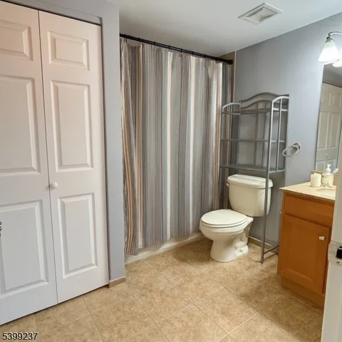 a bathroom with a toilet a sink and a mirror