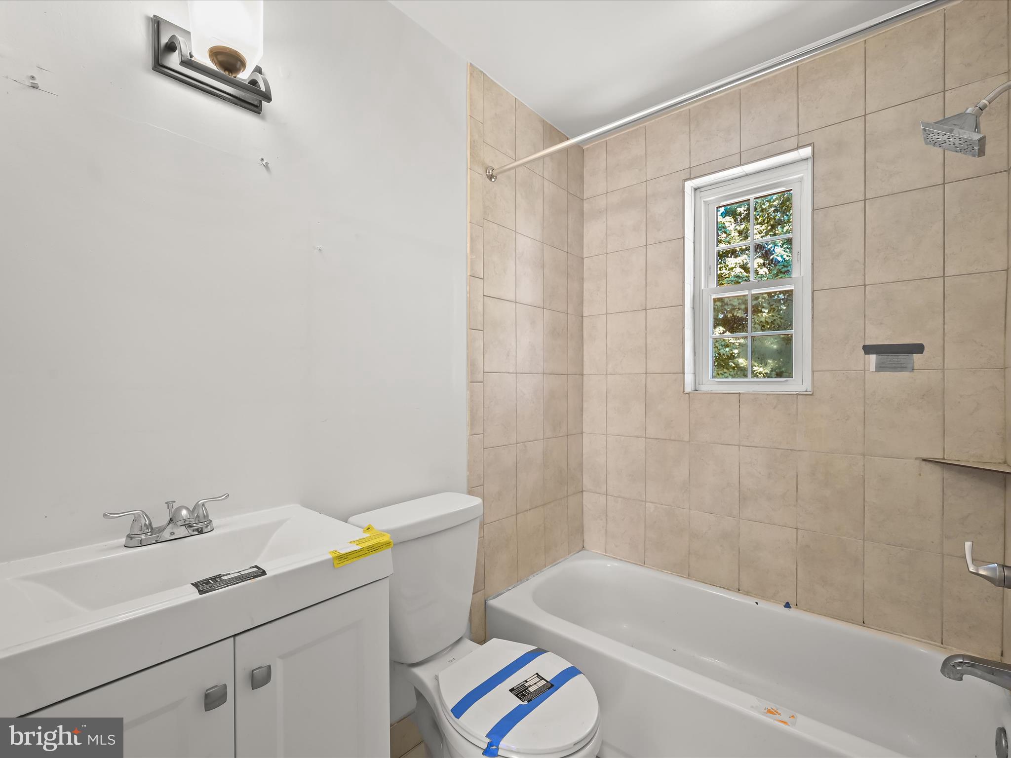 1776 East W Highway, Unit 1776 Silver Spring, MD 20910 - Photo 18 of 31 a bathroom with a sink a toilet and shower