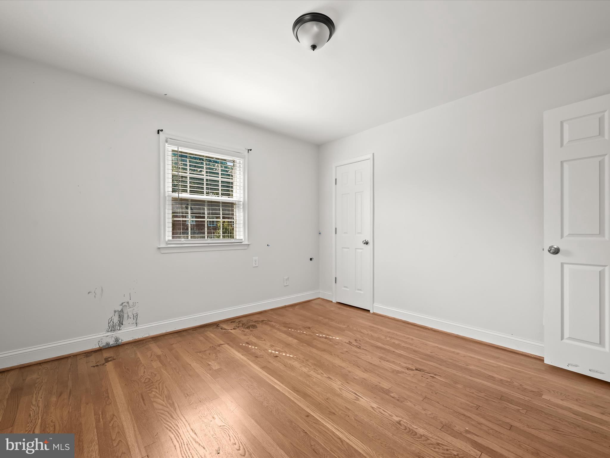 1776 East W Highway, Unit 1776 Silver Spring, MD 20910 - Photo 20 of 31 an empty room with wooden floor and windows