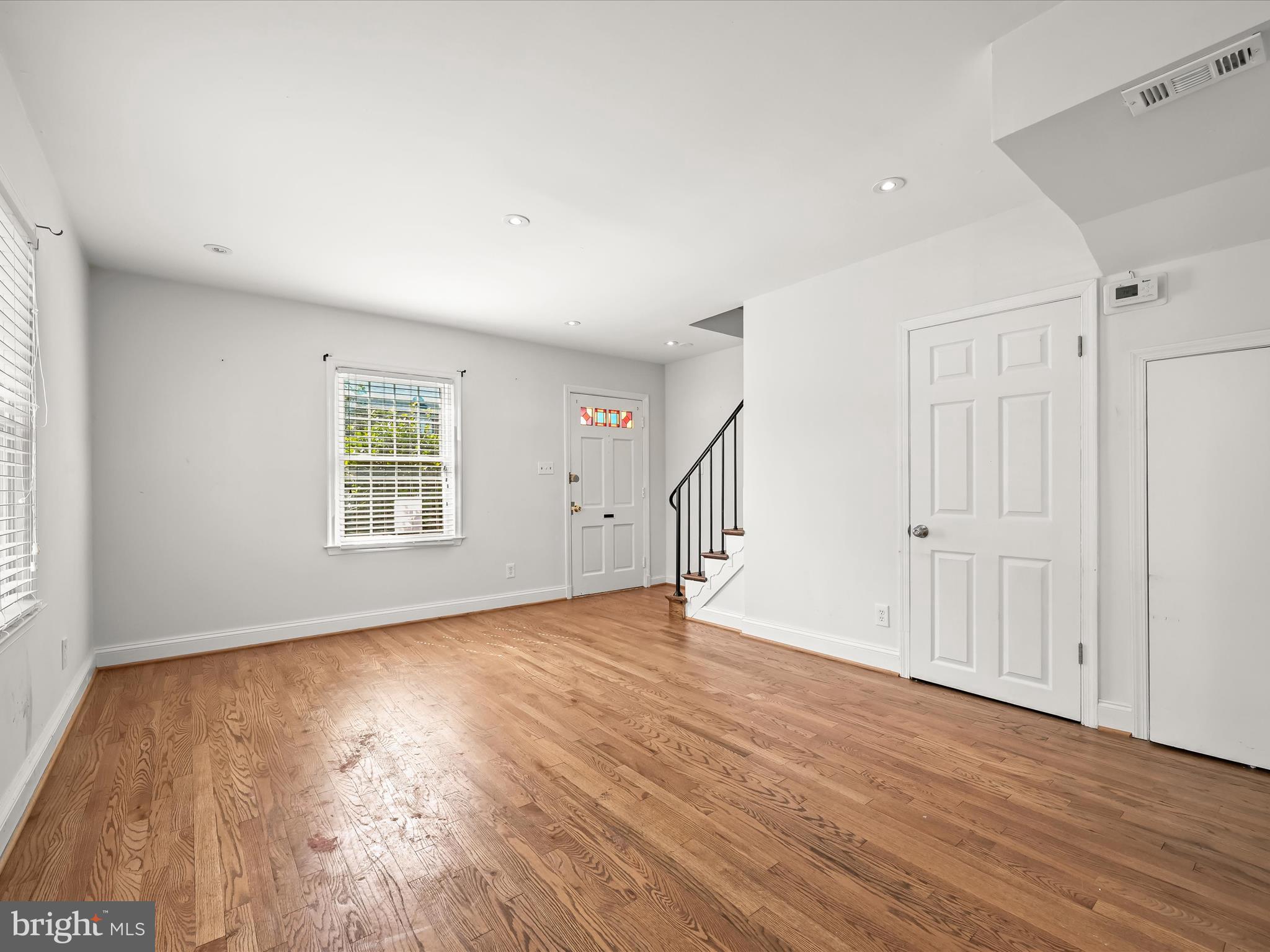 1776 East W Highway, Unit 1776 Silver Spring, MD 20910 - Photo 6 of 31 wooden floor in an empty room with a window