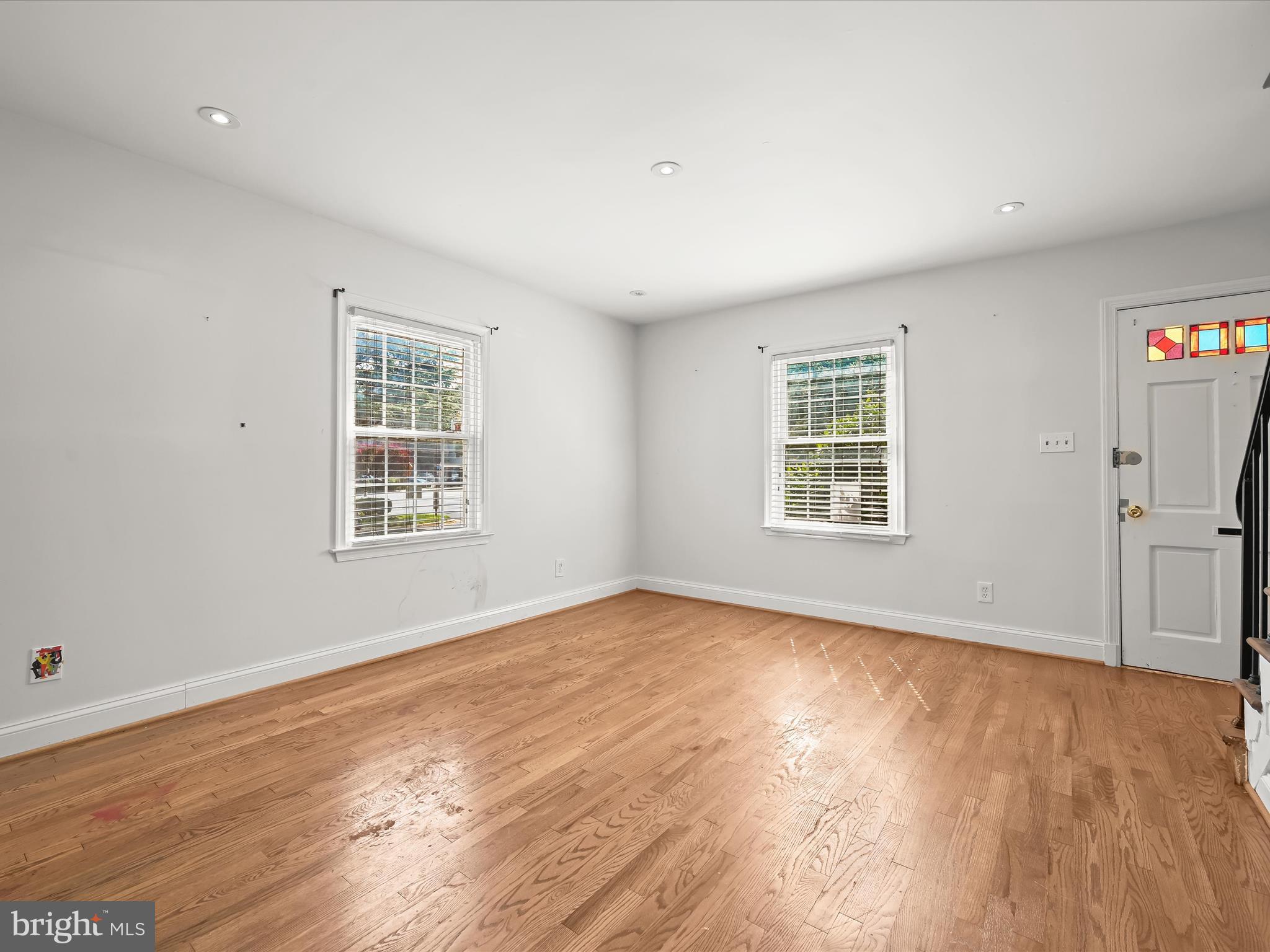 1776 East W Highway, Unit 1776 Silver Spring, MD 20910 - Photo 8 of 31 an empty room with wooden floor and windows