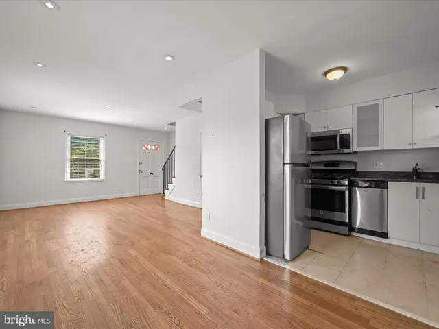a view of kitchen with sink and stainless steel appliances