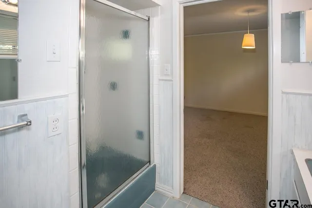 a bathroom with a glass shower door
