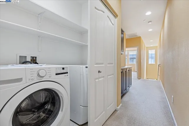 a view of a hallway with washer and dryer