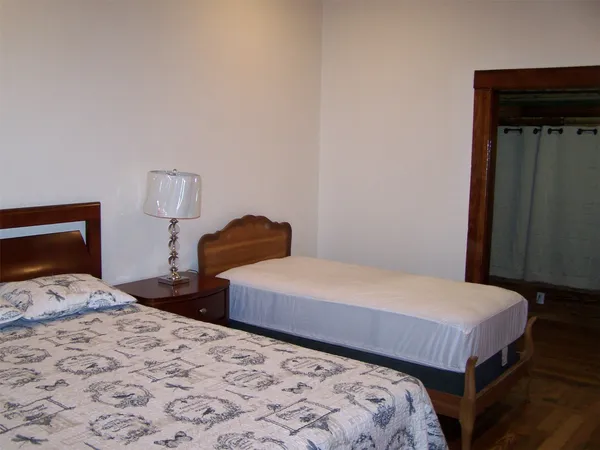a bedroom with a bed and two lamp