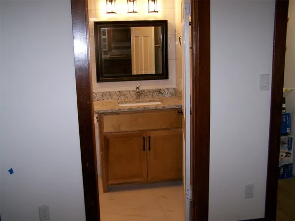 a bathroom with a sink and a mirror