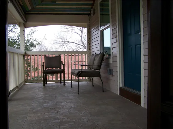 a view of two chairs in the balcony