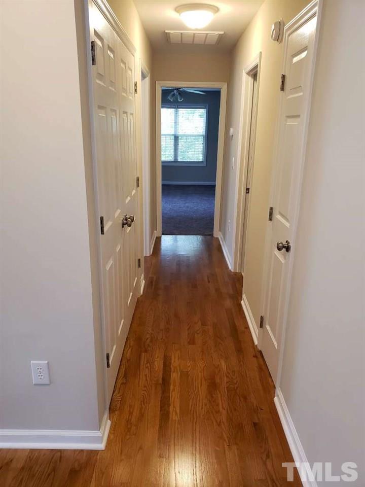 1208 Blackburn Road Apex, NC 27502 - Photo 24 of 26 From the top of the stairs, down the hall into the bonus room.