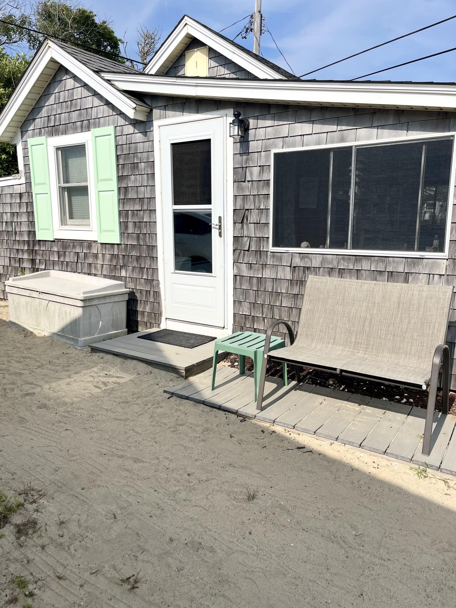217 Old Wharf Road, Unit 64 Dennis Port, MA 02639 - Photo 3 of 16 a view of a house with a large windows