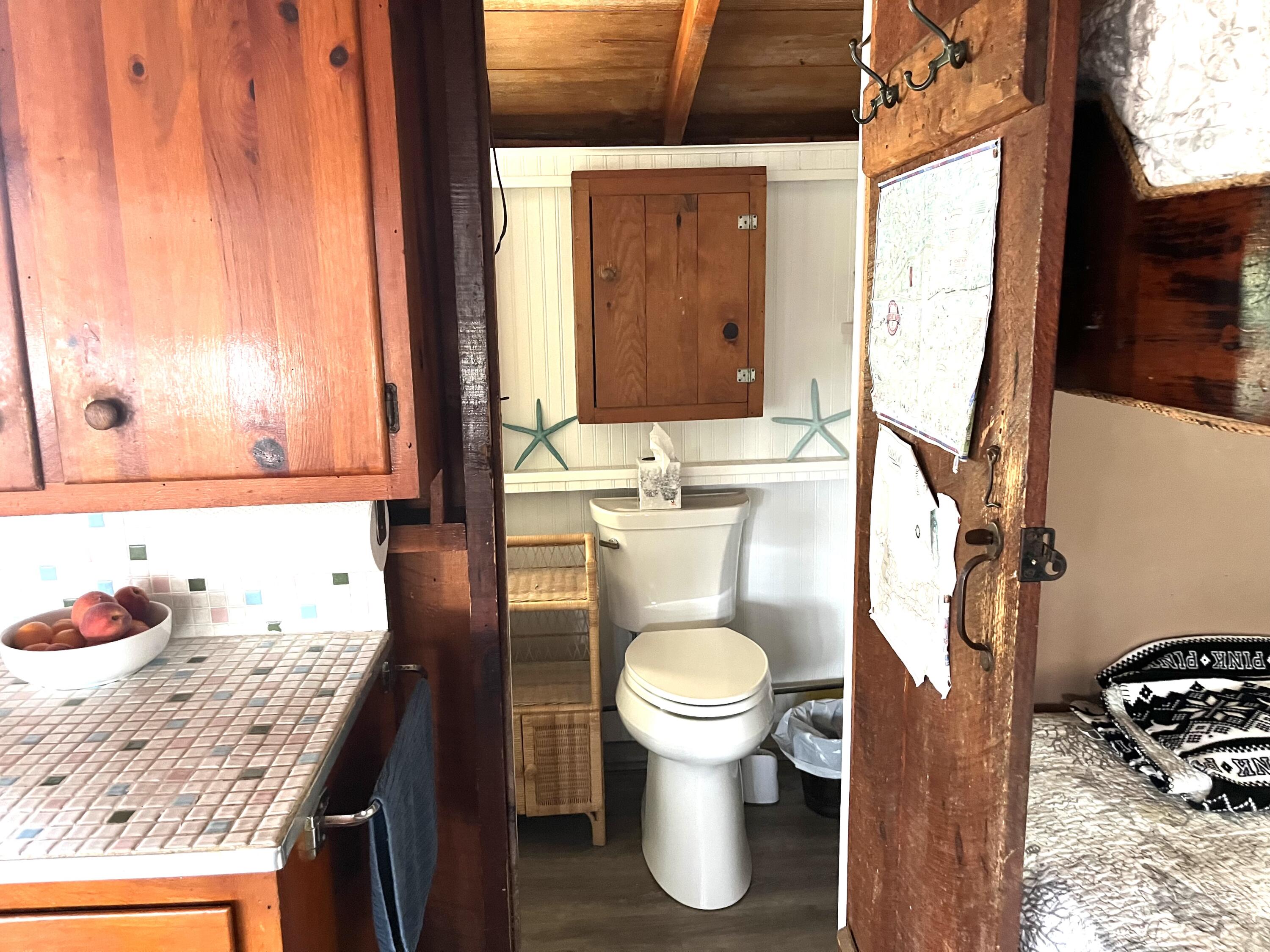 217 Old Wharf Road, Unit 64 Dennis Port, MA 02639 - Photo 10 of 16 a bathroom with a granite countertop sink toilet and mirror