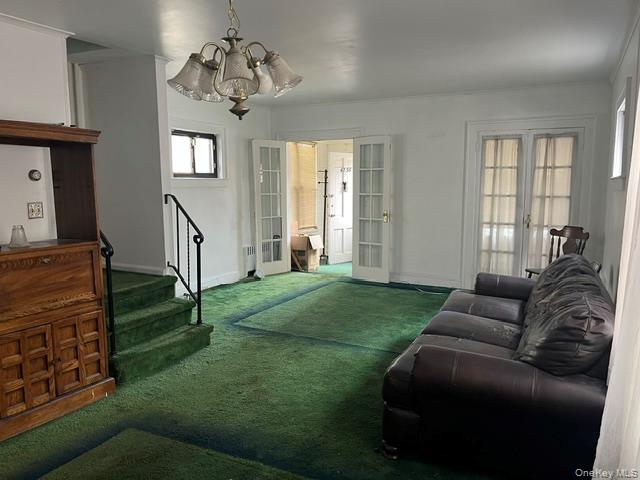 42-36 156th Street Queens, NY 11355 - Photo 7 of 12 a living room with furniture and a chandelier