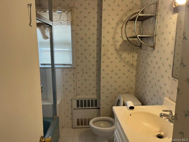 42-36 156th Street Queens, NY 11355 - Photo 8 of 12 a bathroom with a sink a toilet and shower