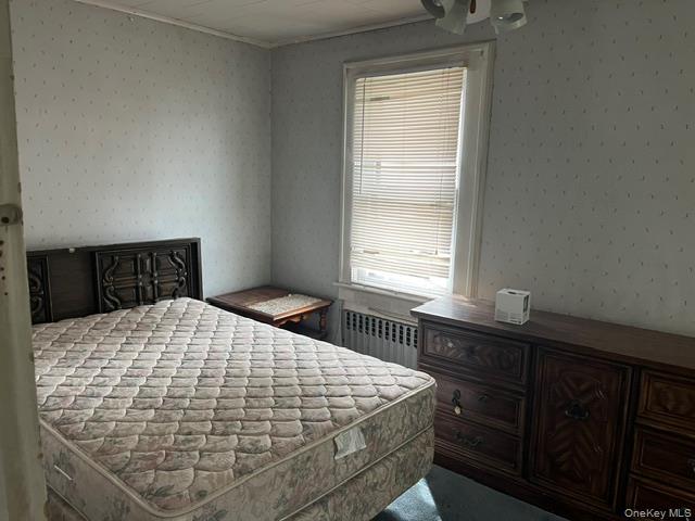 42-36 156th Street Queens, NY 11355 - Photo 9 of 12 a bedroom with a bed and window