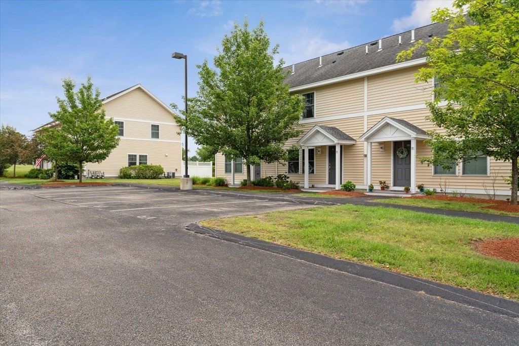 6 Bates Street, Unit B Devens, MA 01434 - Photo 29 of 30 a front view of a house with a yard and trees