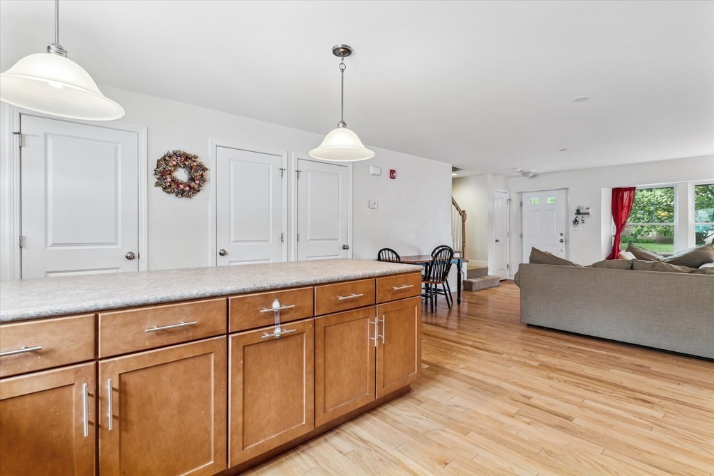 6 Bates Street, Unit B Devens, MA 01434 - Photo 5 of 30 a living room with stainless steel appliances granite countertop furniture and a wooden floor