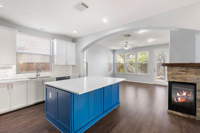 a kitchen with a sink and a fireplace