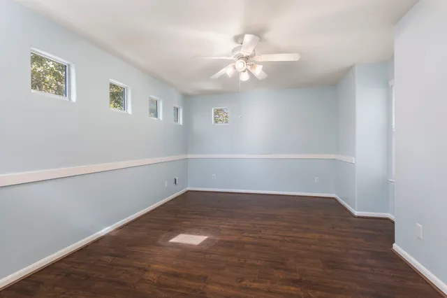 a view of an empty room with wooden floor