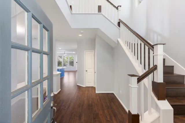 a view of entryway with wooden floor and stairs