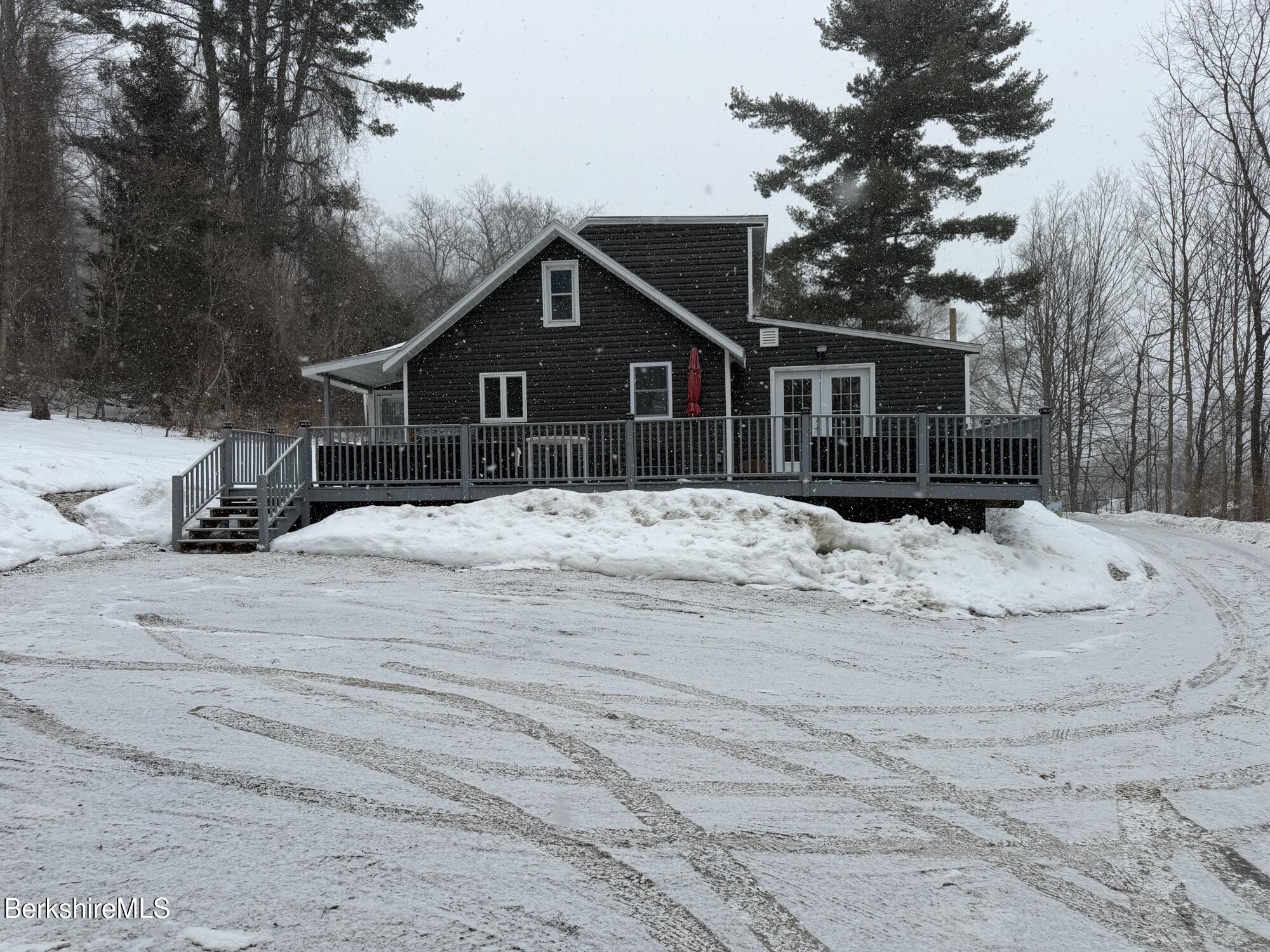 63 Addison Street North Adams, MA 01247 - Photo 1 of 17 a view of a house with a snow in the yard