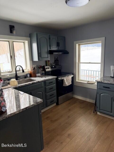 63 Addison Street North Adams, MA 01247 - Photo 2 of 17 a kitchen with granite countertop a stove a sink and a refrigerator