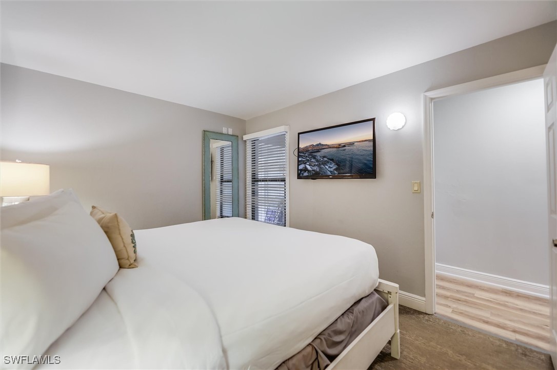 2117 Gulf Beach Villas Captiva, FL 33924 - Photo 15 of 24 a bedroom with a bed and painting on the wall