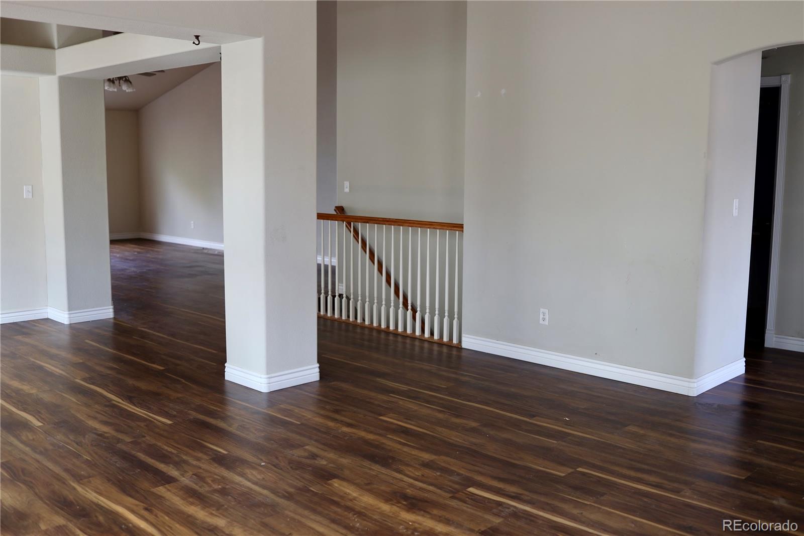 3461 Maple Circle Brighton, CO 80601 - Photo 13 of 27 a view of a hallway with wooden floor