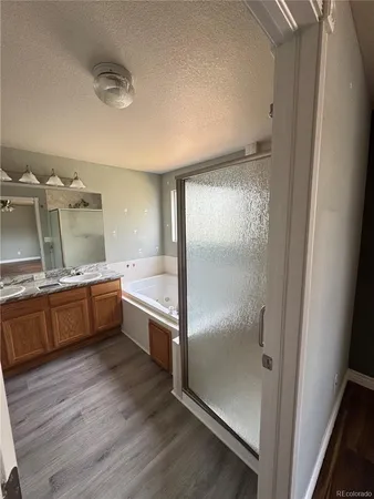 a large kitchen with a wooden floor and a large window