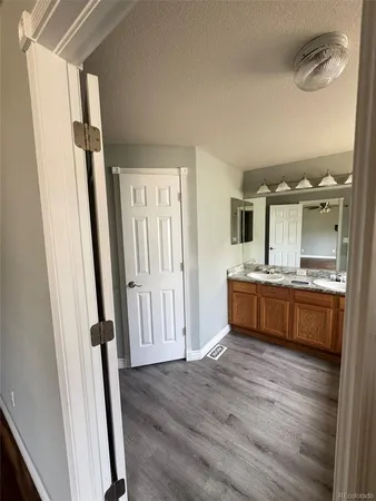 a large bathroom with a sink a mirror and a shower