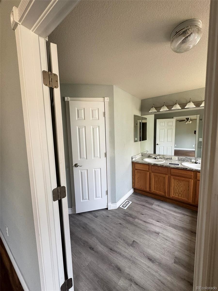 3461 Maple Circle Brighton, CO 80601 - Photo 21 of 27 a large bathroom with a sink a mirror and a shower