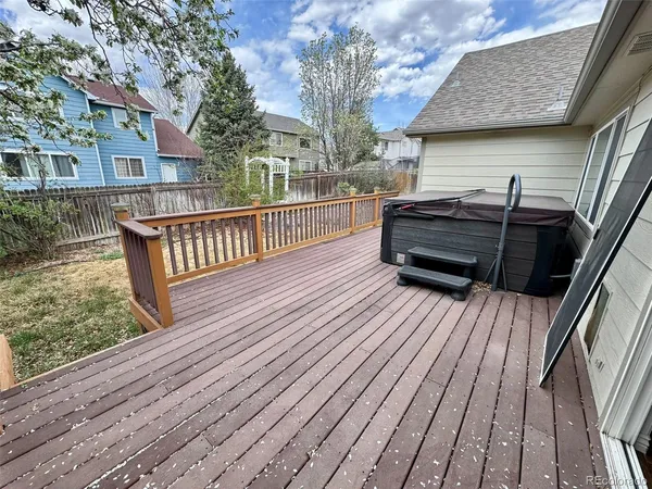 a view of a roof deck with wooden floor and fence