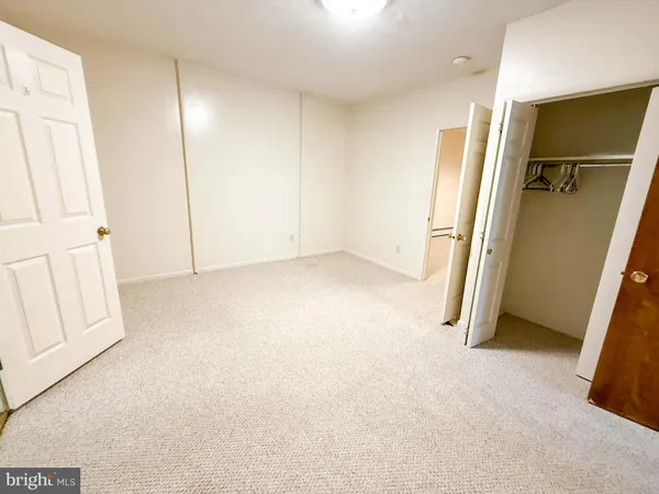 a view of an empty room with a kitchen